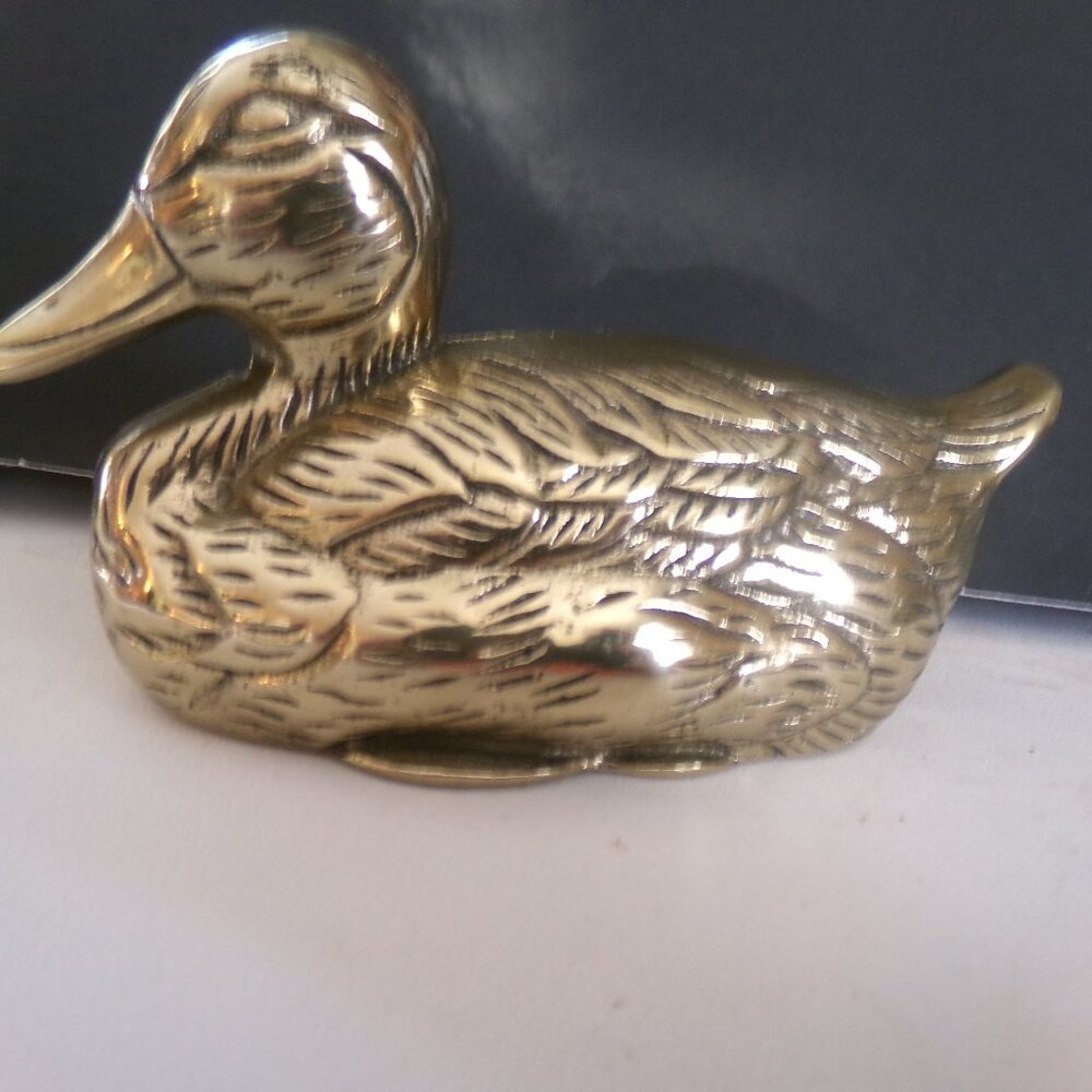 brass duck figure.